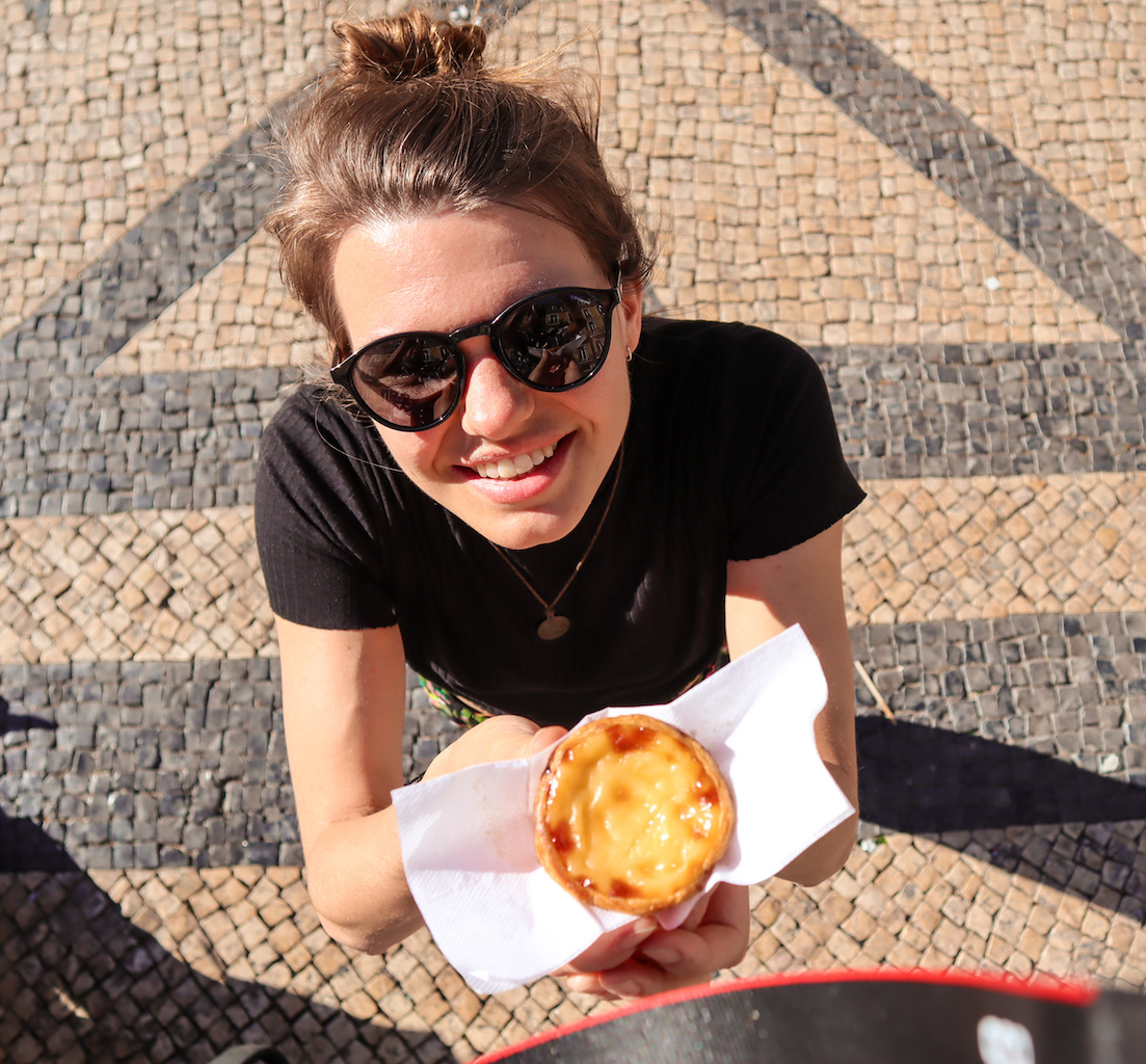 A girl smiling with a Pastel de Nata